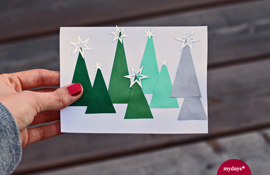 die selbst gestaltete Weihnachtskarte mit Christbäumen und Sternen